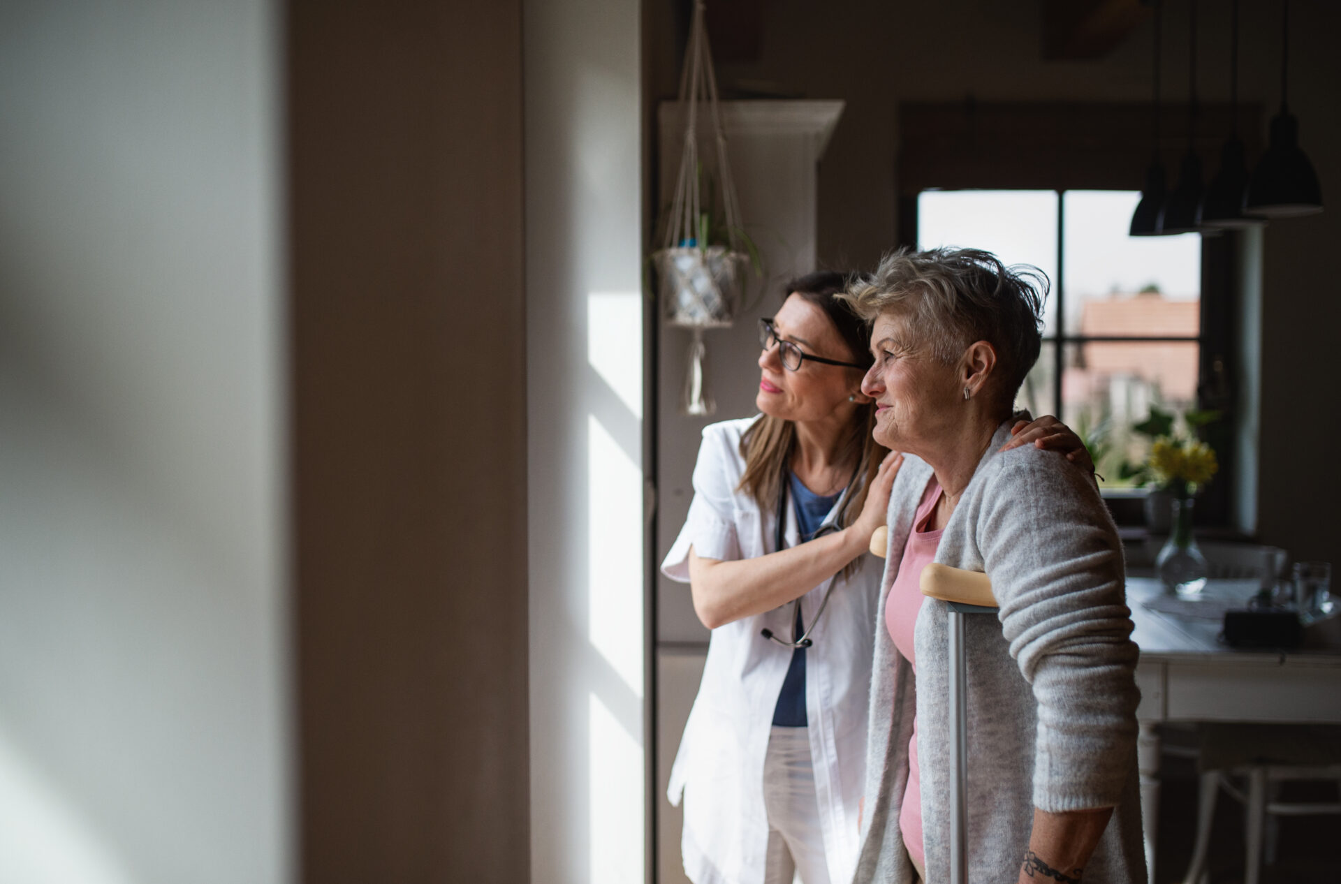 Caregiver helping Senior with Osteoarthritis become more mobile.