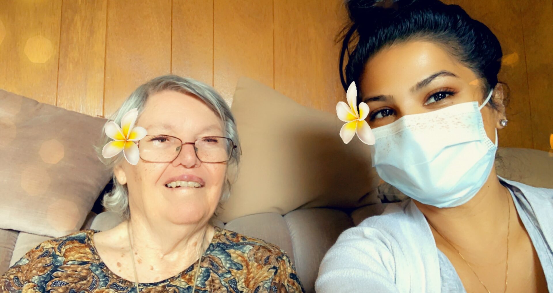 A CareHop caregiver takes a picture while giving a plant to her client.