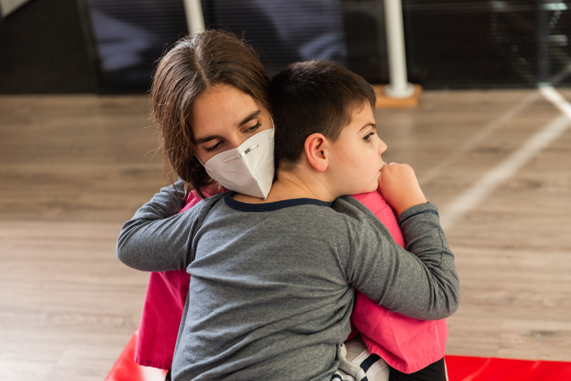 Young patient and Pediatric nurse hugging.