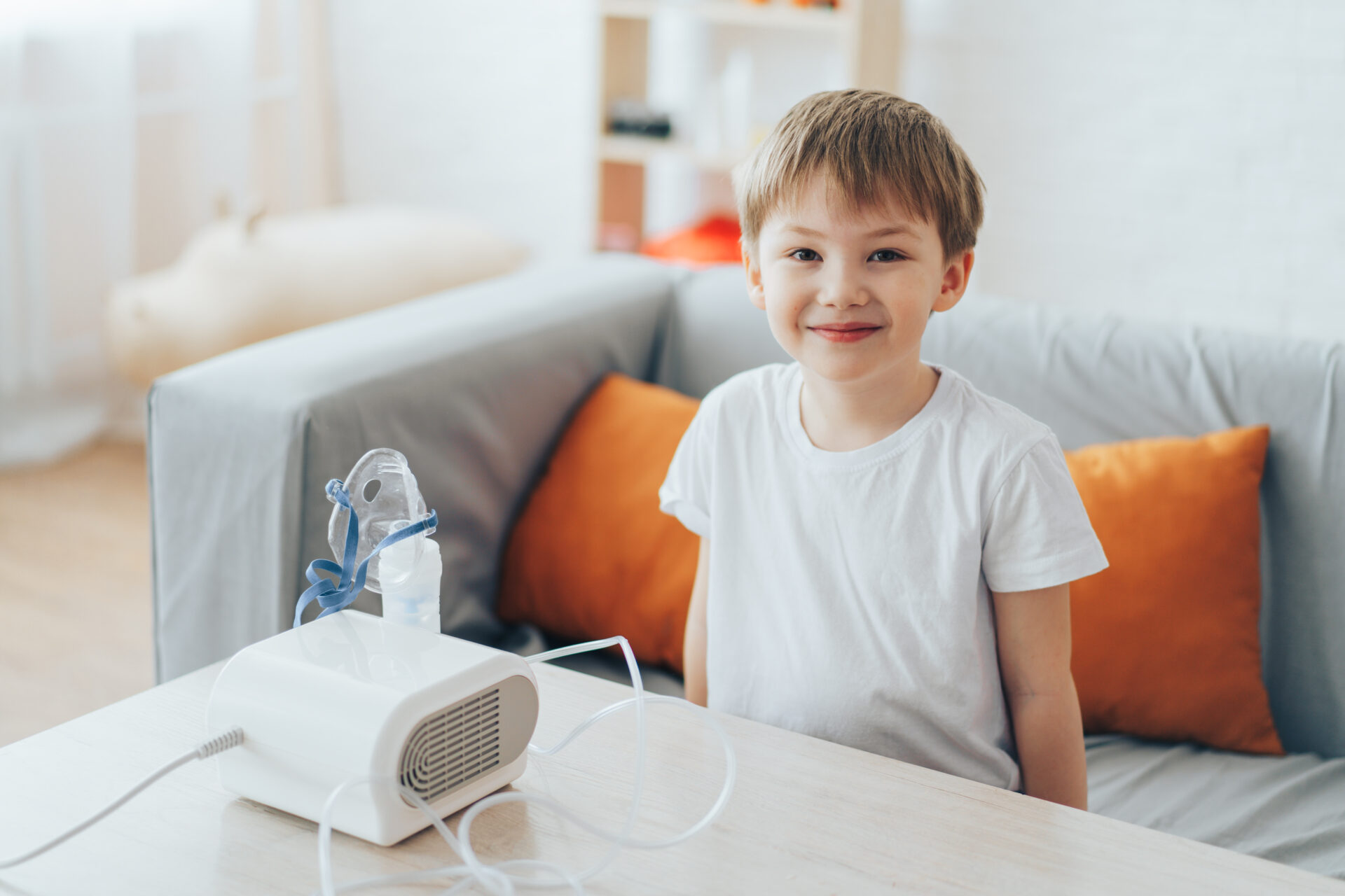 Pediatric patient on the couch about to use nebulizer