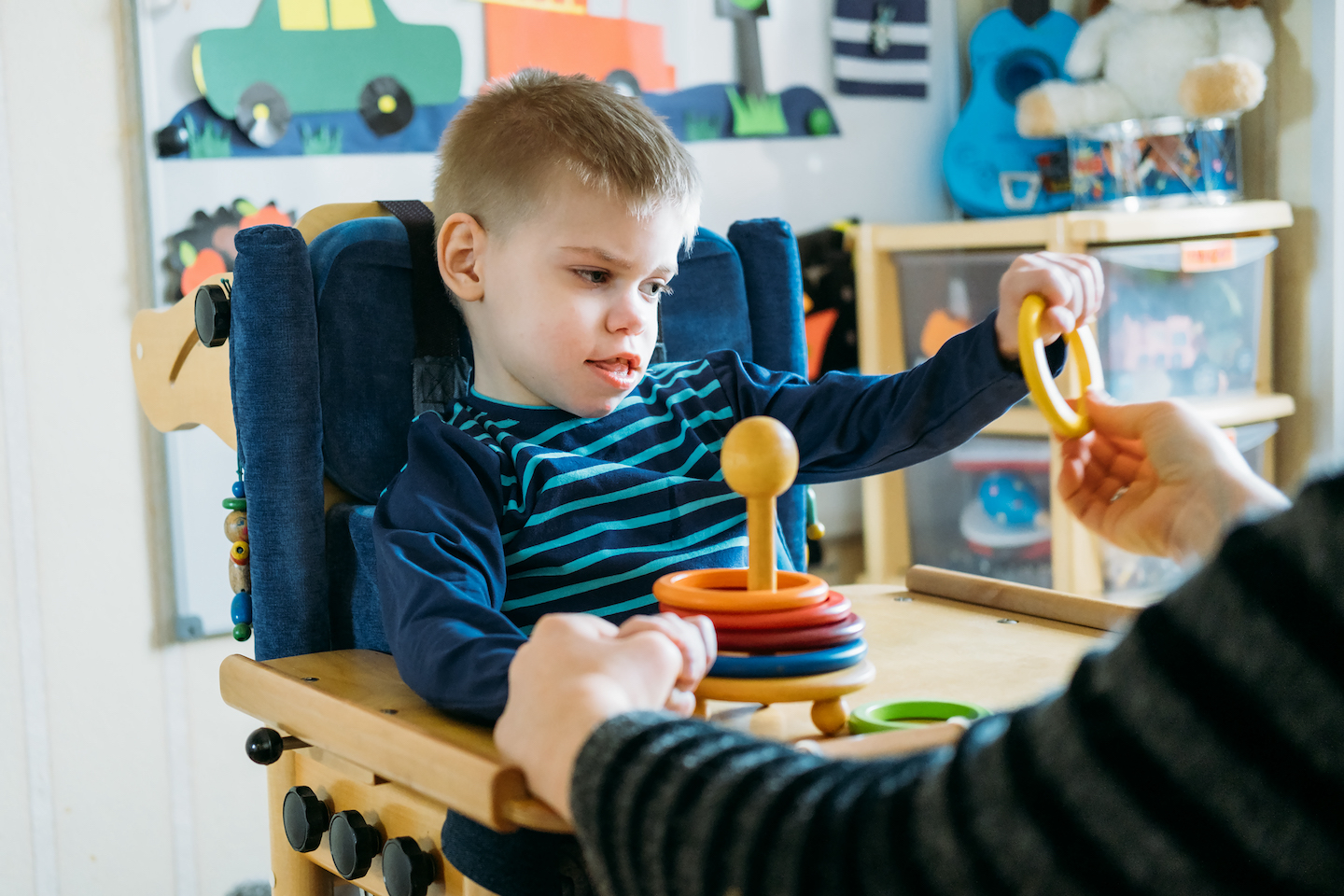 Nurse reading a story to pediatric patient at home.