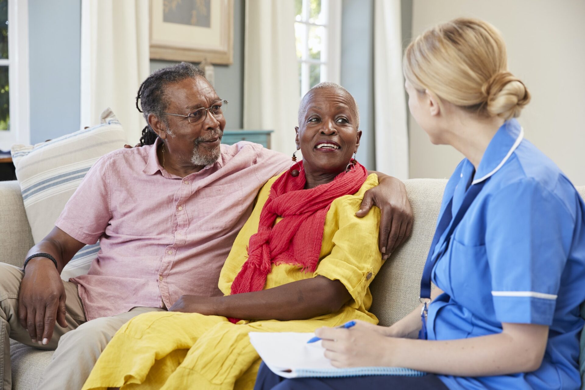 Female Community Nurse Visits Senior Couple At Home