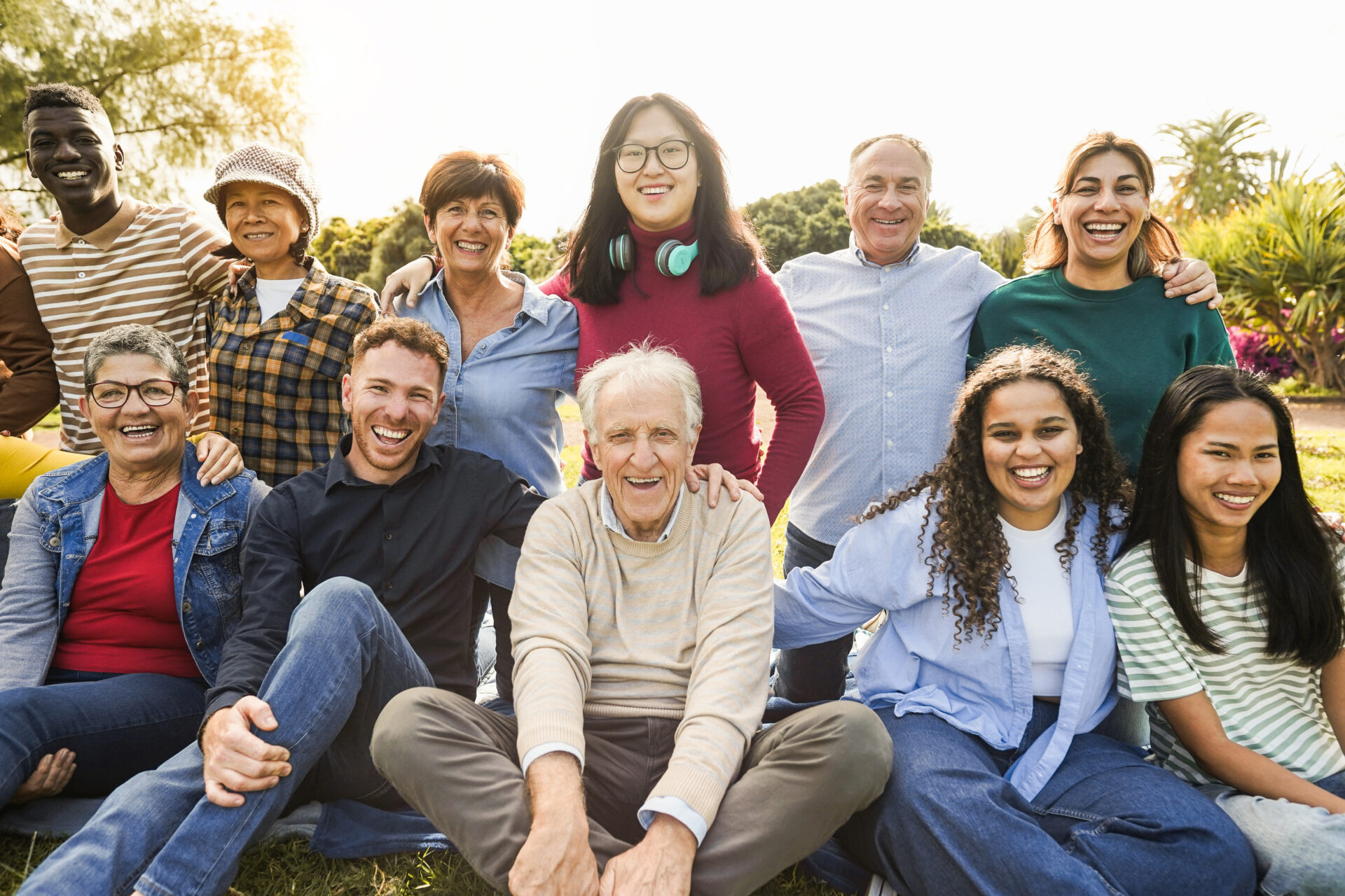 Multigenerational family group smiling together.