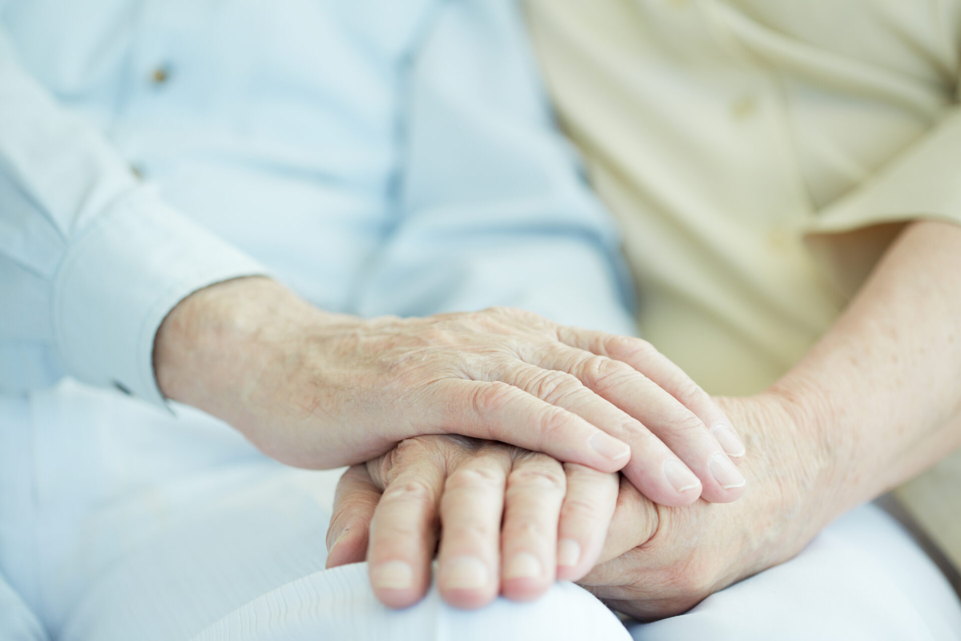 Health visitor and a senior man with tablet during home visit.