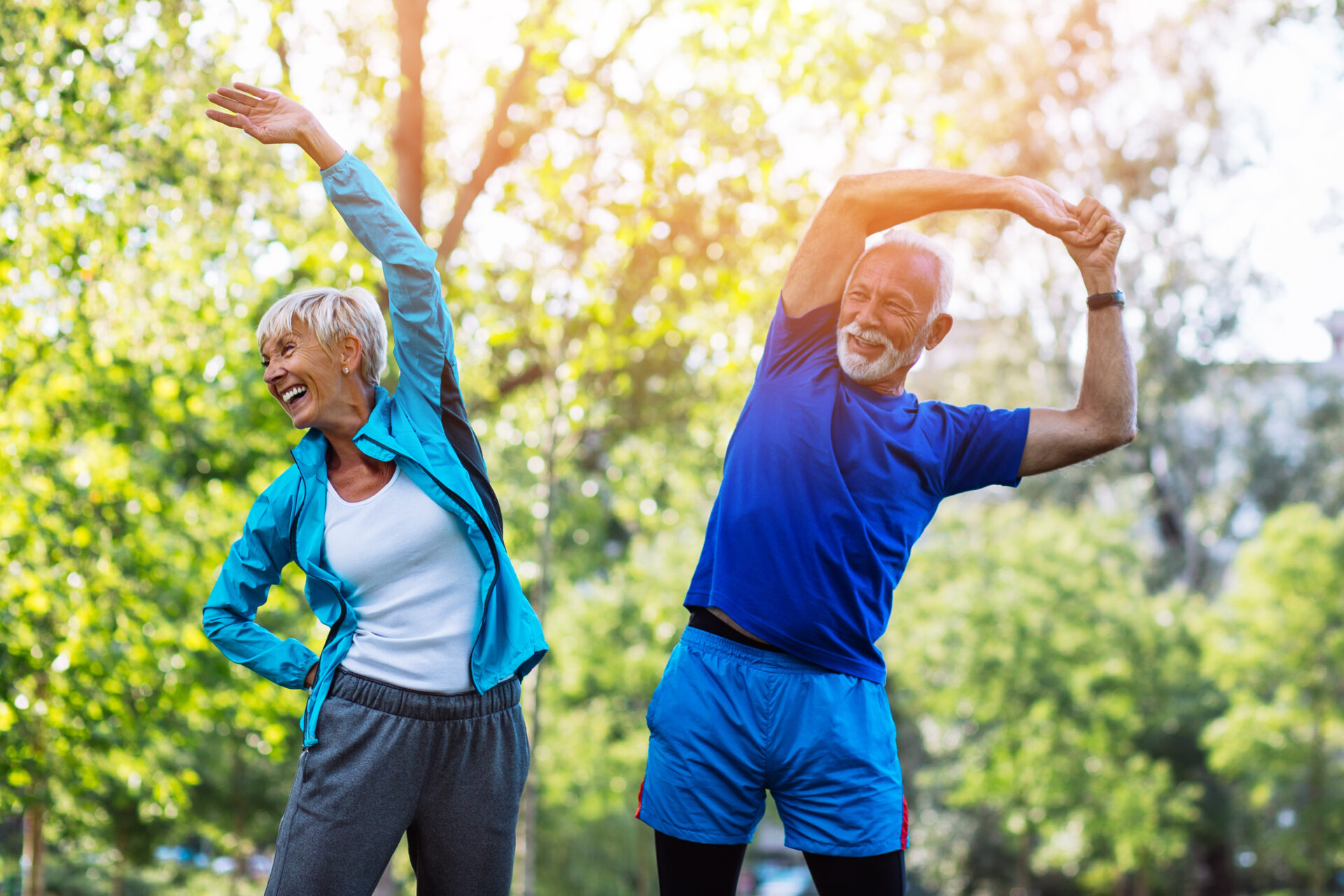 Asian senior couple practicing tai chi outside by the river