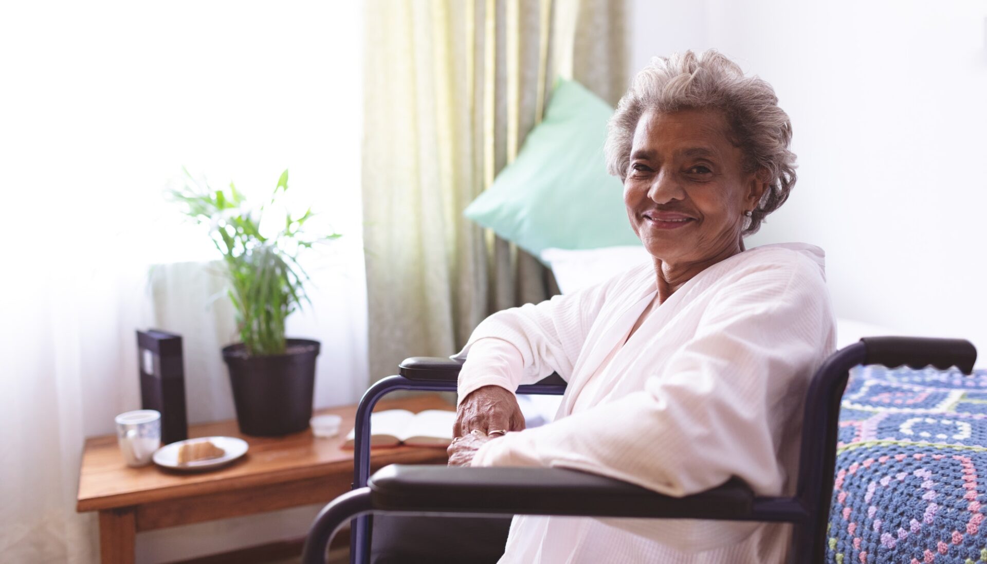 Senior woman sitting in wheelchair at nursing home