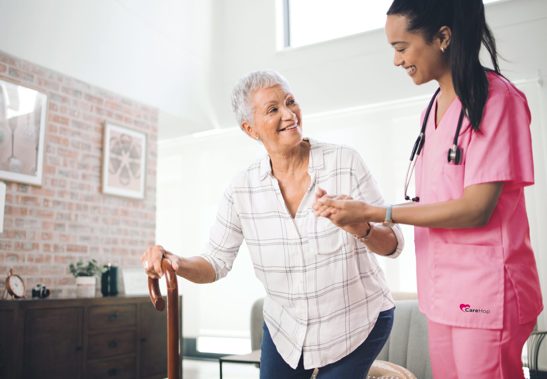 Shot of an older woman using a walking stick and walking with the assistance of a physiotherapist.